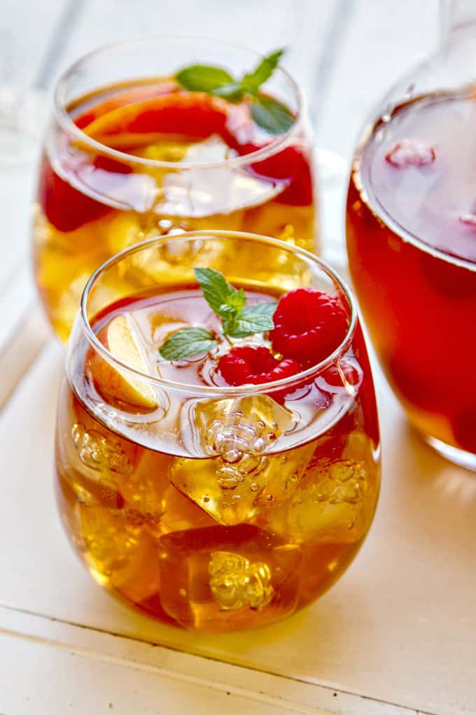 Sweet-tea-sangria-with-peaches. A party isn't a party without some crowd pleasing cocktails. Save your sanity at your next party by having a few of these make-ahead big batch cocktails mixed and ready to serve. Click here to check out these delicious big batch cocktail recipes now.