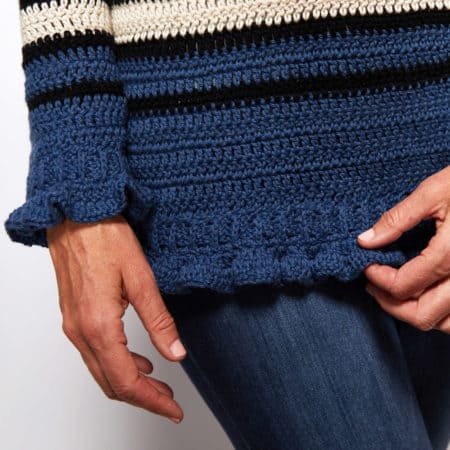 If you’re looking for an adorable classic sweater, look no further than the Breton Ruffle Cuff Sweater! #crochetpattern #crochettop #crochetsweater #crochetlove #crochetaddict