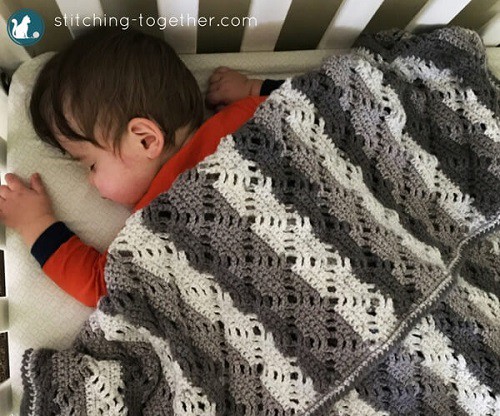 Diamond Lace Baby Blanket - These lace baby blanket patterns are gentle, soft and cozy. Make a special family keepsake with one of these free crochet baby blanket patterns. #BabyBlanketCrochetPatterns #CrochetPatterns #LaceBabyBlanket #CrochetAddict