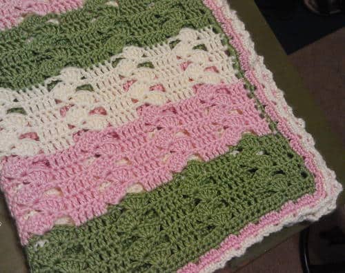 Light and Lacy Crochet Baby Blanket - These lace baby blanket patterns are gentle, soft and cozy. Make a special family keepsake with one of these free crochet baby blanket patterns. #BabyBlanketCrochetPatterns #CrochetPatterns #LaceBabyBlanket #CrochetAddict