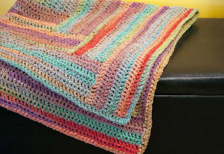 Log Cabin Afghan - Crochet afghans are colorful and exciting and full of life. There’s so much room for creativity in these crochet blanket patterns. #CrochetAfghans #CrochetPatterns #CrochetBlankets