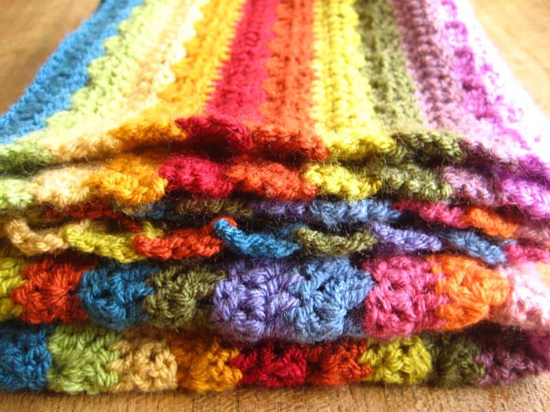Relaxing Rainbow Blanket - Crochet afghans are colorful and exciting and full of life. There’s so much room for creativity in these crochet blanket patterns. #CrochetAfghans #CrochetPatterns #CrochetBlankets