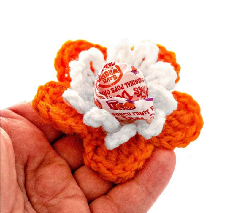 Flower Lolli Holders - Learn how to crochet a flower and bring the magic of nature into your life with these crochet patterns.  Each one is unique and colorful. #CrochetFlowerPatterns #CrochetPatterns #FreeCrochetPatterns
