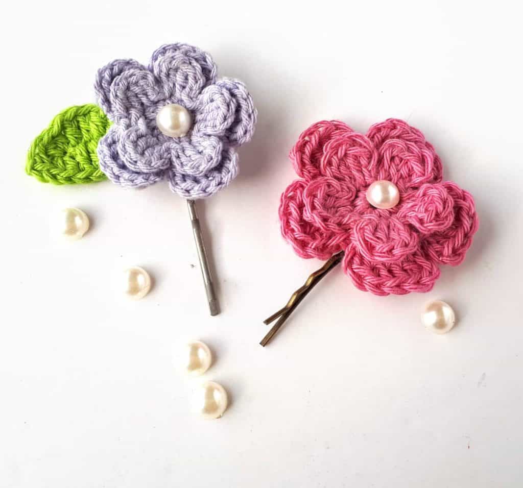 Spring Flower Hair Clips - Learn how to crochet a flower and bring the magic of nature into your life with these crochet patterns.  Each one is unique and colorful. #CrochetFlowerPatterns #CrochetPatterns #FreeCrochetPatterns