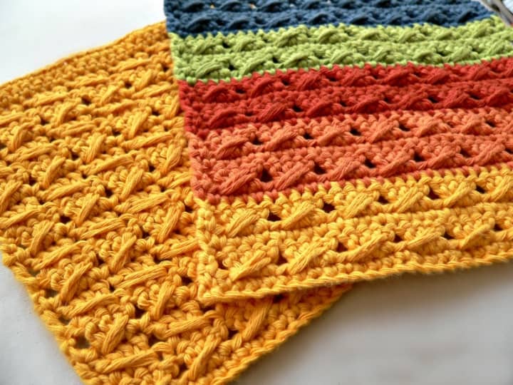 Crochet Cable Stitch Dishcloth - These crochet dishcloth patterns are all free and are so different from each other. Test your creativity with one of these brilliant dishcloth patterns. #CrochetDishclothPatterns #CrochetPatterns #DishclothPatterns