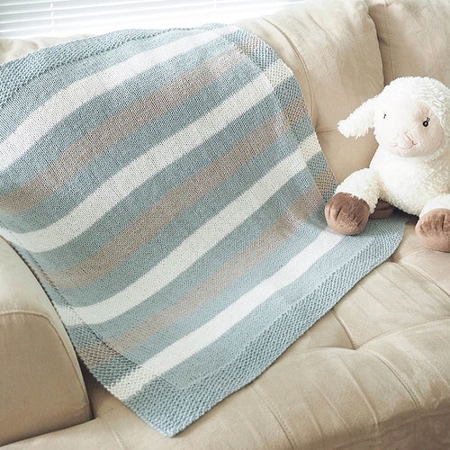 Easy Striped Baby Blanket - These knitting patterns for baby blankets are easy and adorable you might find yourself making more than just one! #knittingpatterns #babyblanketknittingpatterns #babyblankets