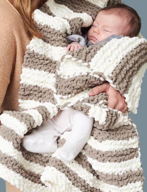 In A Wink Baby Blanket - These knitting patterns for baby blankets are easy and adorable you might find yourself making more than just one! #knittingpatterns #babyblanketknittingpatterns #babyblankets
