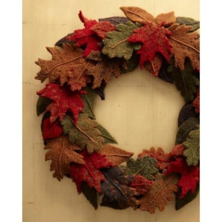 Knit Fall Wreath - We’ve got 16 quick and easy Thanksgiving knitting patterns for anything from hats, to centerpiece decorations. #knittingpatterns #thanksgivingknittingpatterns #freeknittingpatterns