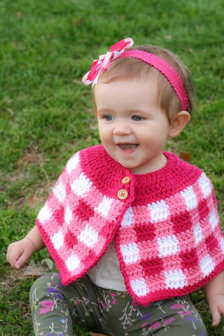 Plaid Cape for Babies and Girls - Check out this list of ‘love’-ly easy crochet projects you can do for the ones you love. These range from easy trinkets, wreaths and blankets. #EasyCrochetProjects #CrochetPatterns #ValentineCrochetPatterns