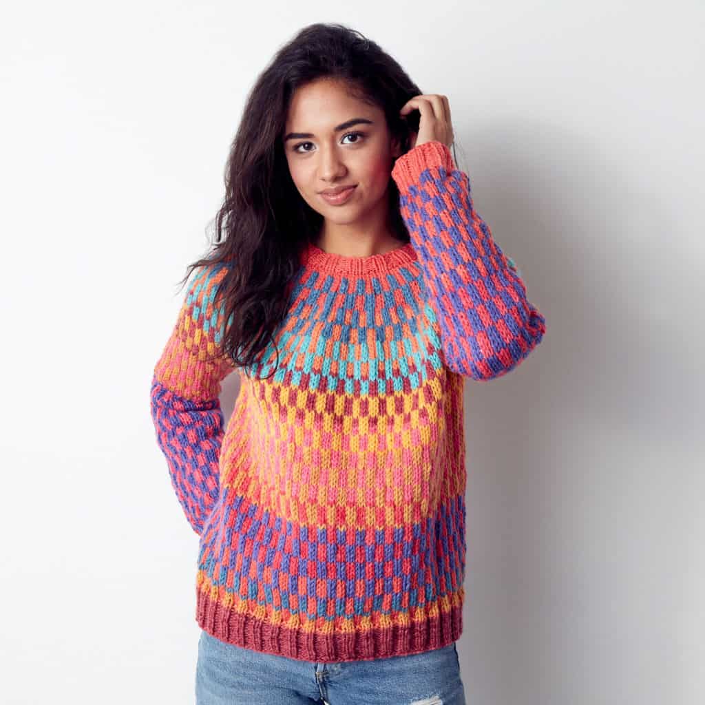 Bernat On Repeat Knit Pullover - Keep yourself warm and comfy this season by knitting one of these knitted sweater patterns. You can choose from the basic pullover to a more daring design. #knittedsweaterpatterns #knittingpatterns #knitsweaterpatterns