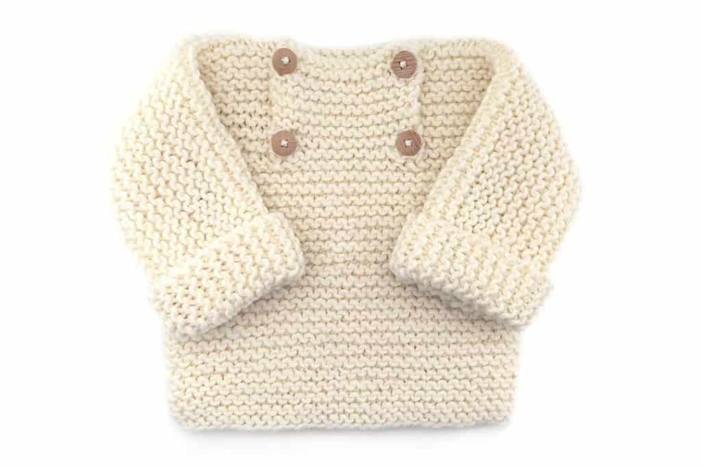 Garter Stitch Baby Sweater - Keep yourself warm and comfy this season by knitting one of these knitted sweater patterns. You can choose from the basic pullover to a more daring design. #knittedsweaterpatterns #knittingpatterns #knitsweaterpatterns