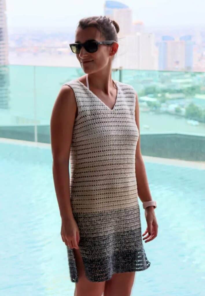 woman wearing sunglasses and crochet dress next to a pool