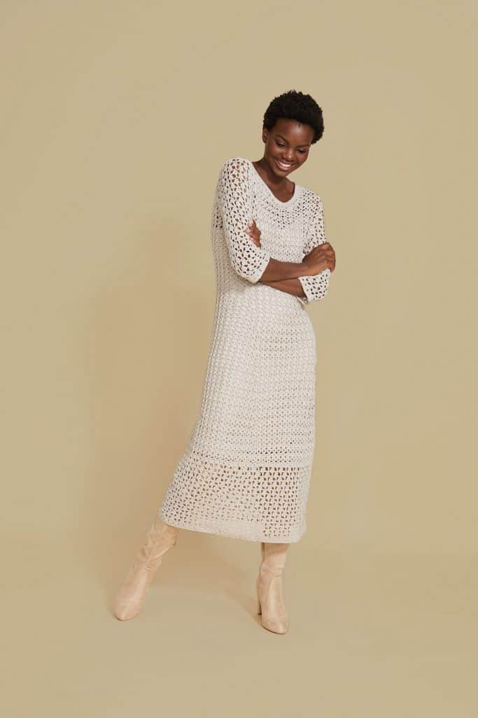 woman wearing a white lace crochet dress and boots