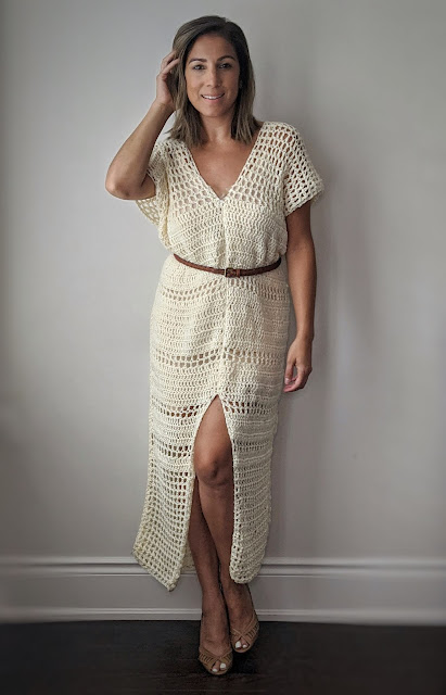 woman wearing a fron slit crochet dress with a thin belt
