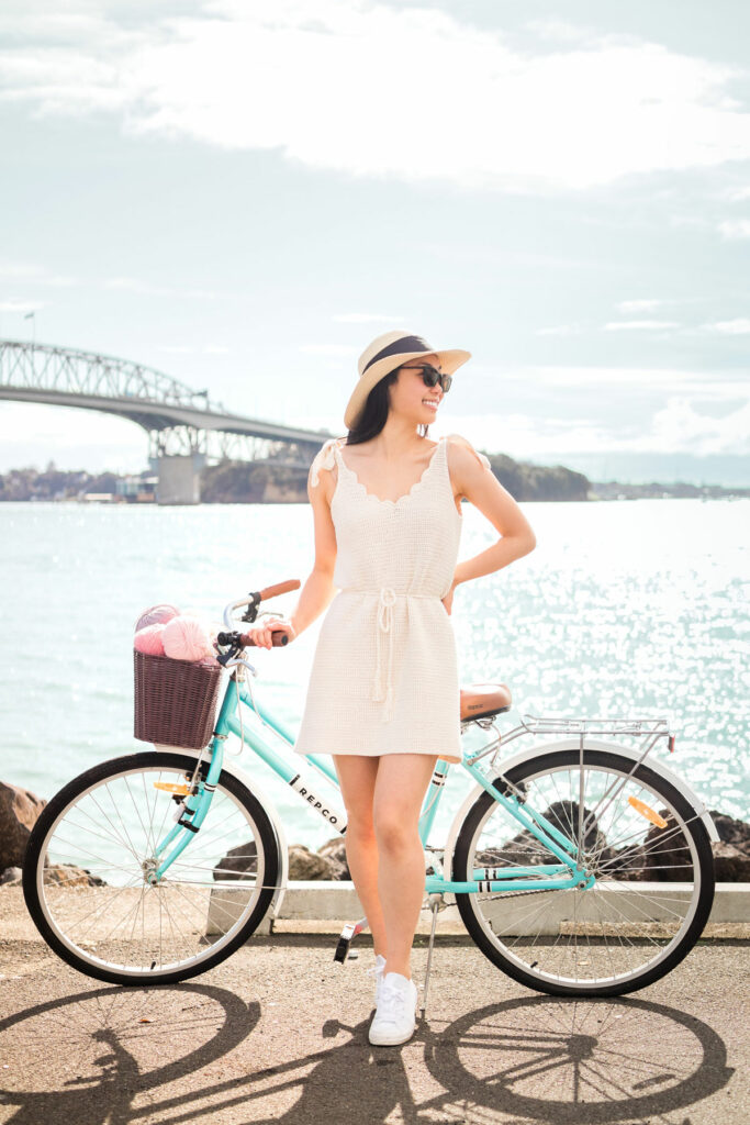 woman with a bike wearing V-neck summer crochet dress