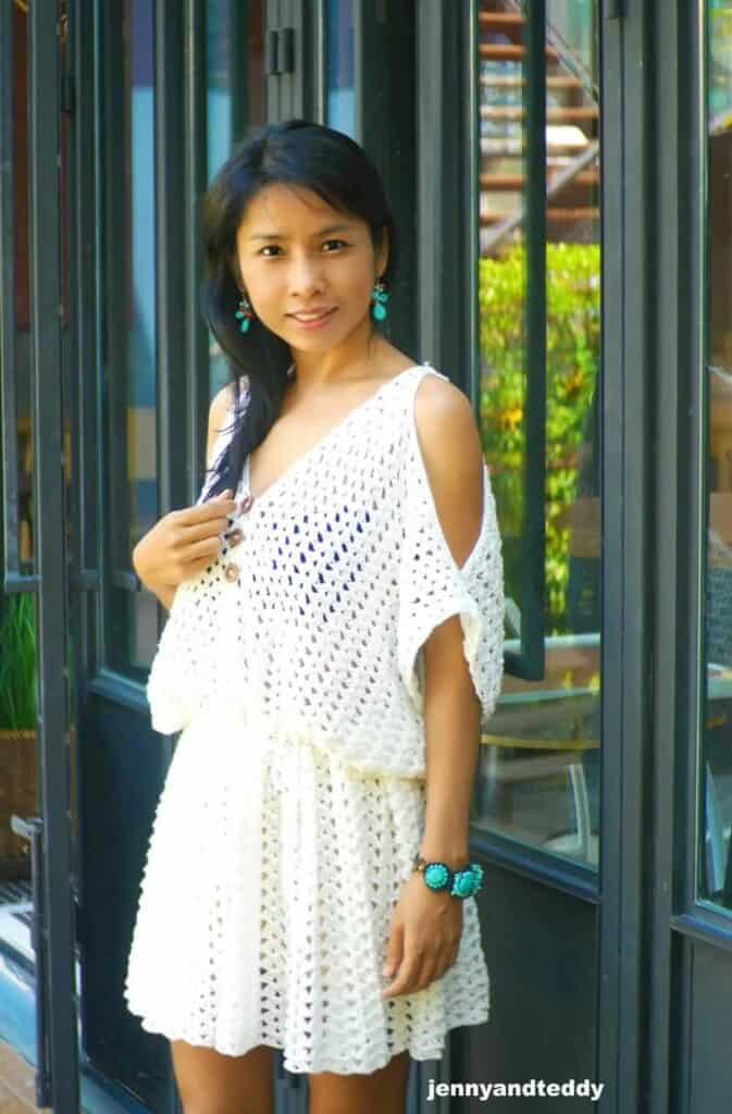 woman wearing a white crochet boho mini dress