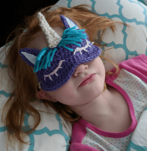 Girl wearing unicorn sleep mask crochet pattern