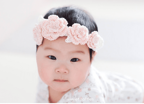 Baby girl wearing crochet lacy flower crown