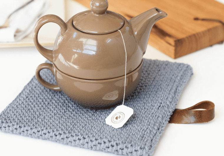 A teapot on a Modern Crochet Hot Pad 