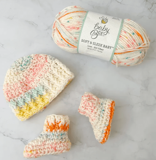 Yarn, crochet booties and a newborn crochet hat