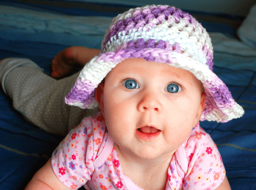 A baby wearing the Pansy Crochet Sun Hat
