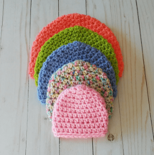 Simple Crochet Hats on a wooden surface
