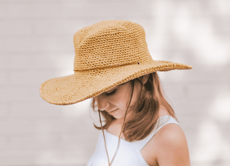 A girl wearing the Cleo Fedora Mini Crochet Sun Hat