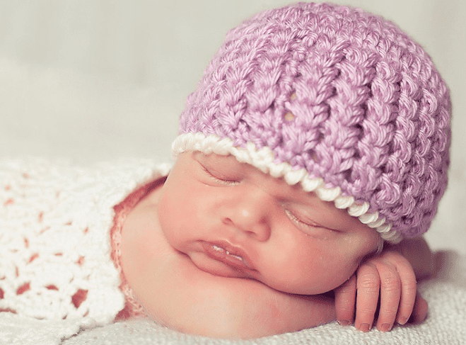 A newborn wearing the Trinity Stitch Crochet Hat