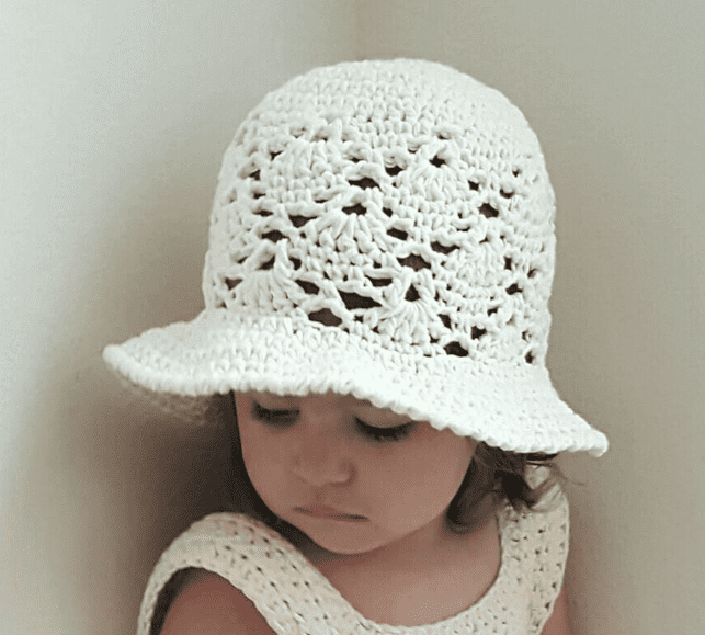 A kid wearing a Vintage Crochet  Sun Hat